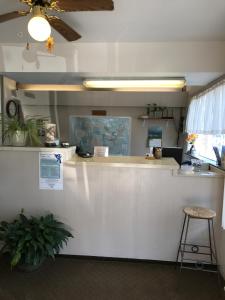 a white counter with a bar in a room at The Evergreen Motel in Kansas in Pratt