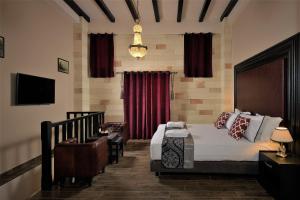 a bedroom with a bed and a red curtain at Grand Master Suite in Rhodes Town
