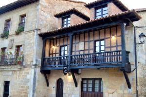 un edificio con un balcón en el lateral. en Suites con Jacuzzi Santillana, en Santillana del Mar