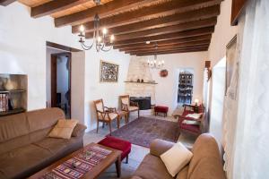 a living room with a couch and a table at DROUSHIA CORNER HOUSE in Drousha