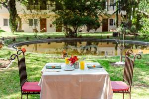 einen Tisch mit einem weißen Tischtuch und Blumen darauf in der Unterkunft Lila Hotel in Atotonilco