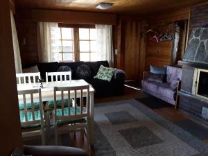 a living room with a couch and a fireplace at Rantapuro in Alvajärvi