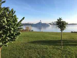 a cruise ship in the water with a tree at NAUTIK STRANDAPARTMENTS Luxuswohnung Atlantik in Brake
