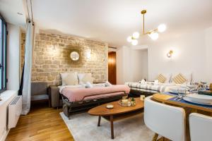 a living room with a brick wall at Wonderful home in PARIS in Paris