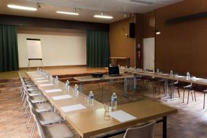 a room with tables and chairs with water bottles on them at Evasion Tonique in Villers-le-Lac