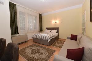 a bedroom with a bed and a couch at Apartment Nikola in Belgrade