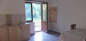 a kitchen with a sink and a door to a porch at Arami Guest House in Dilijan