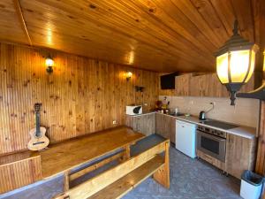 a kitchen with a bench in a wooden wall at Family Hotel Kavrakovi in Pavel Banya