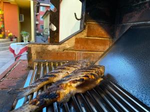 a pair of fish cooking on a grill at Family Hotel Kavrakovi in Pavel Banya