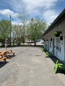 a group of picnic tables outside of a building at Motel Giffard in Quebec City +23 photos