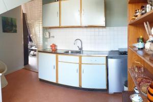 a kitchen with white cabinets and a sink at appartement Kemperberg in Arnhem +20 photos