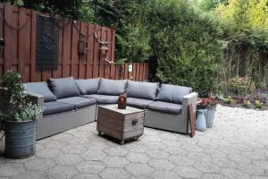 a patio with a blue couch and a table at appartement Kemperberg in Arnhem