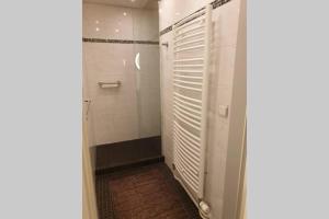 a walk in shower with white doors in a bathroom at appartement Kemperberg in Arnhem