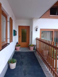 a porch of a house with potted plants and a door at Landhaus-Königsberg, Vorberg 360 in Ramsau am Dachstein