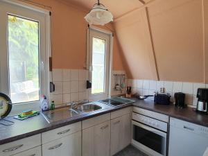 a kitchen with a sink and a window at Ferienhaus am Helenesee 1 in Frankfurt Oder