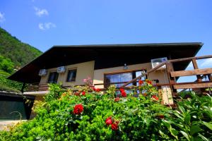 a house with red flowers in front of it at Na Kopitarjevi in Laško