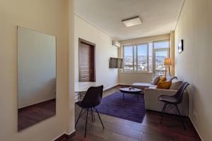 a living room with a couch and a table at Acropolis comfy home in the heart of Athens for 4 in Athens