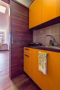 a kitchen with yellow cabinets and a sink at Acropolis comfy home in the heart of Athens for 4 in Athens