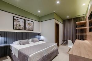 a bedroom with a bed and a book shelf at Avenida Hotel in Sorriso