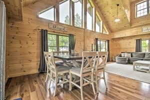 a dining room with a table and chairs at Lake View and Hot Tub Wrightsville Cabin! in Wrightsville