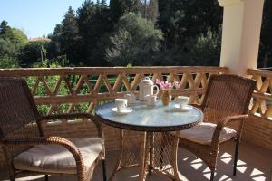 a table and two chairs on a patio at Eleas gi (Olive Grove Estate) in Tsilivi