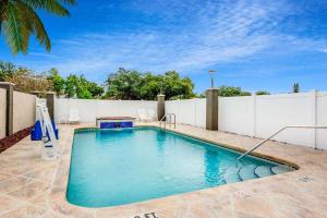 a swimming pool in a backyard with a white fence at La Quinta by Wyndham St. Petersburg Northeast *Newly Renovated in St. Petersburg