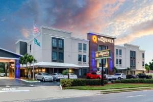 a hotel with cars parked in a parking lot at La Quinta by Wyndham St. Petersburg Northeast *Newly Renovated in St Petersburg