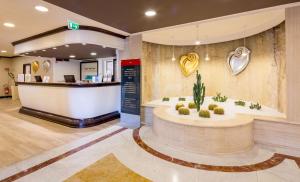 a lobby of a hospital with a wellness center at Best Western Plus Tower Hotel Bologna in Bologna