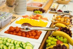 a buffet filled with different types of fruits and vegetables at Villa Marion in Luhačovice +113 photos