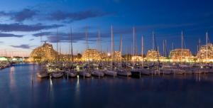 a group of boats docked in a marina at night at ideal appartement au calme prés du Golf in La Grande Motte