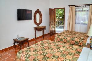 Postel nebo postele na pokoji v ubytování Hotel Spa Posada Tlaltenango