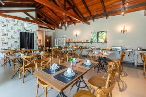 a dining room with wooden tables and chairs at Avenida Hotel in Sorriso