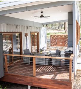a screened in porch with a wooden deck at Tuckers Lane Boutique Accommodation in Rothbury