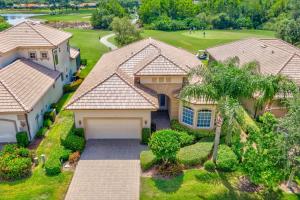 an aerial view of a house with a palm tree at Luxurious Golf Course Getaway with Resort Perks in Naples
