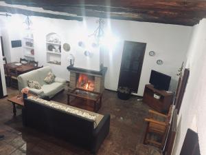 a living room with a couch and a fireplace at Casa Rural Casa Ronda in El Bosque