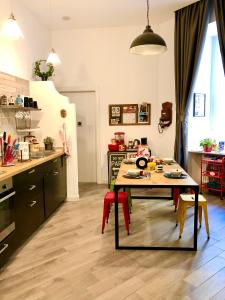 a kitchen with a table and red chairs in a room at M99 Design Rooms in Naples