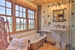 a bathroom with a tub and a sink at Timeless Red Sox Retreat with Scenic Mountain Views! in Putney +24 photos