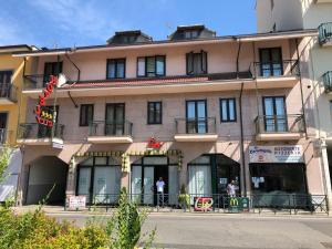 a building with a person standing outside of it at Hotel City in Chivasso