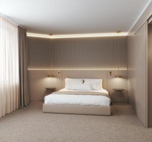 a bedroom with a white bed and white walls at Carlemany Girona in Girona