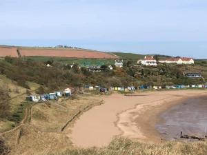 an aerial view of a beach with a group of huts at The Law House in Coldingham