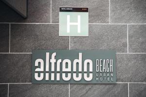 a sign for a hotel on a tile wall at Beach Hotel Alfredo in Las Palmas de Gran Canaria