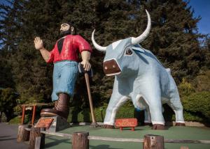 a man standing next to a statue of an elephant at Holiday Inn Express Redwood National Park, an IHG Hotel in Klamath