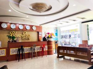 a restaurant with a blue sea hotel with red chairs at Blue Sea Hotel Quy Nhơn - 02 Trần Độc in Quy Nhon