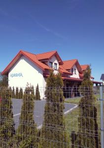 a house with a fence in front of it at Apartamenty Adrenja in Rowy