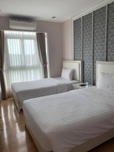 Postel nebo postele na pokoji v ubytování Harmony Resort Hotel