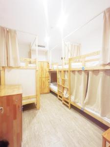 a room with two bunk beds and a desk at Shanghai Blue Mountain Bund Youth Hostel in Shanghai