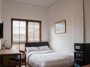 A bed or beds in a room at Rumanami Residence