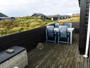 a table and chairs on the deck of a house at 5 person holiday home in Fanø in Fanø