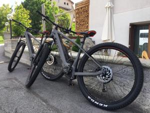 two bikes parked next to each other on a sidewalk at Hotel Helvetia in Müstair