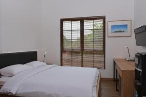 A bed or beds in a room at Rumanami Residence
